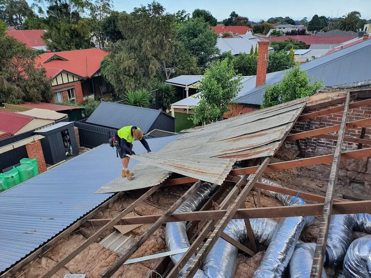 Oz-Adelaide roofer removing old corrugated sheeting from an Adelaide home
